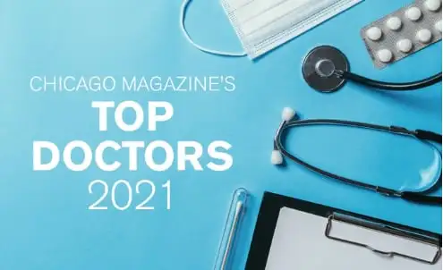 Flat lay image of a stethoscope, mask, pills, and clipboard on a blue background. Text reads Chicago Magazine’s Top Doctors 2021.