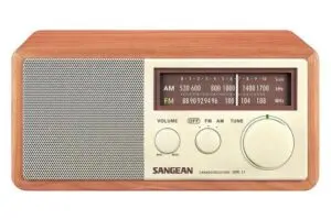 A vintage-style wooden radio with a speaker on the left and a tuning display on the right. It features AM and FM frequencies, volume, band, and tuning knobs. The brand name SANGEAN and model WR-11 are visible on the front.